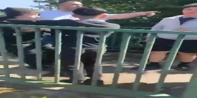 A Parent Holds A Boy While Other Boys Assault Him